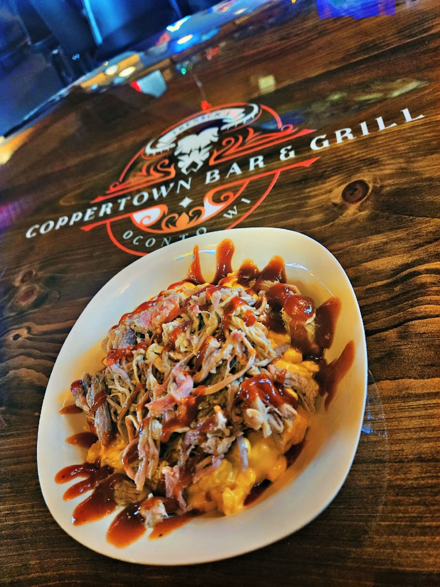 Pulled pork mac and cheese drizzled with BBQ sauce